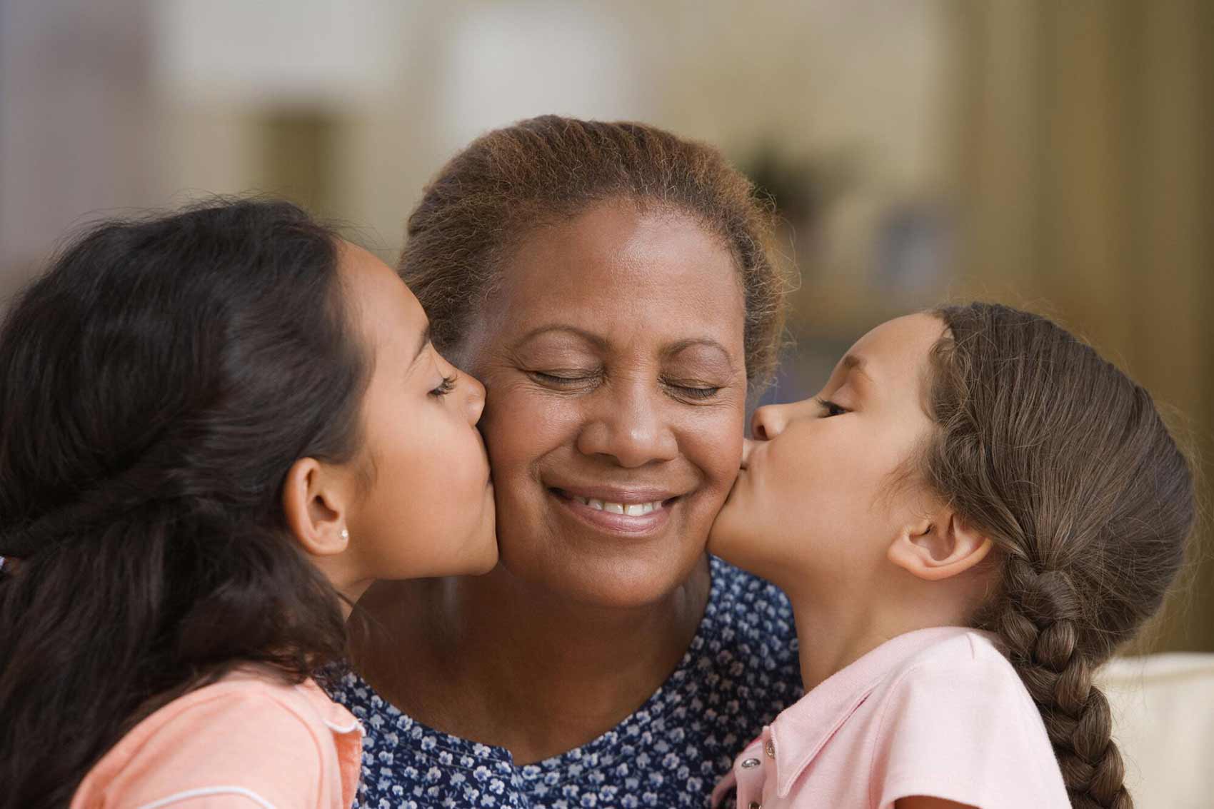 Kids kissing their grandmother