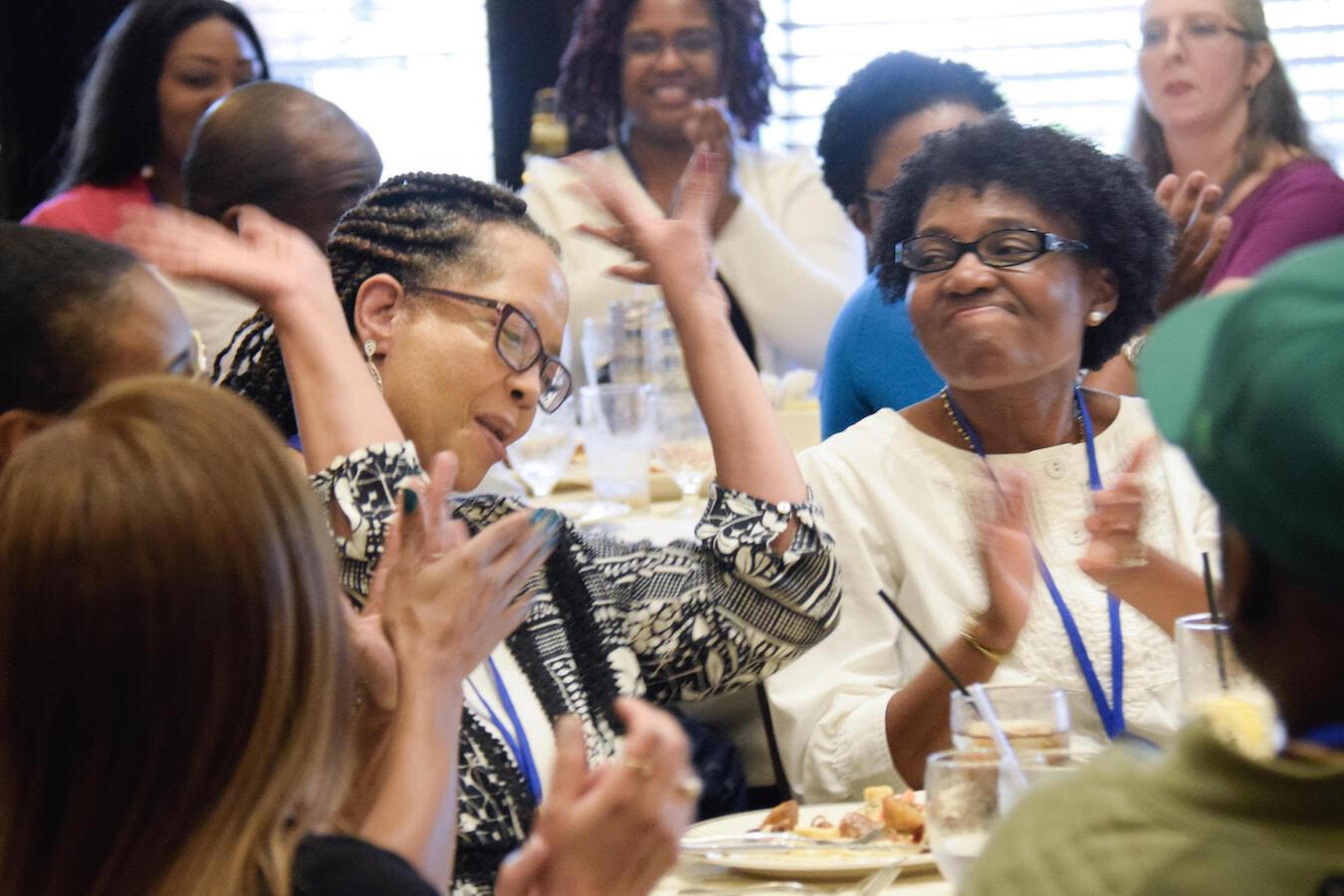 lady raising hand at seminar